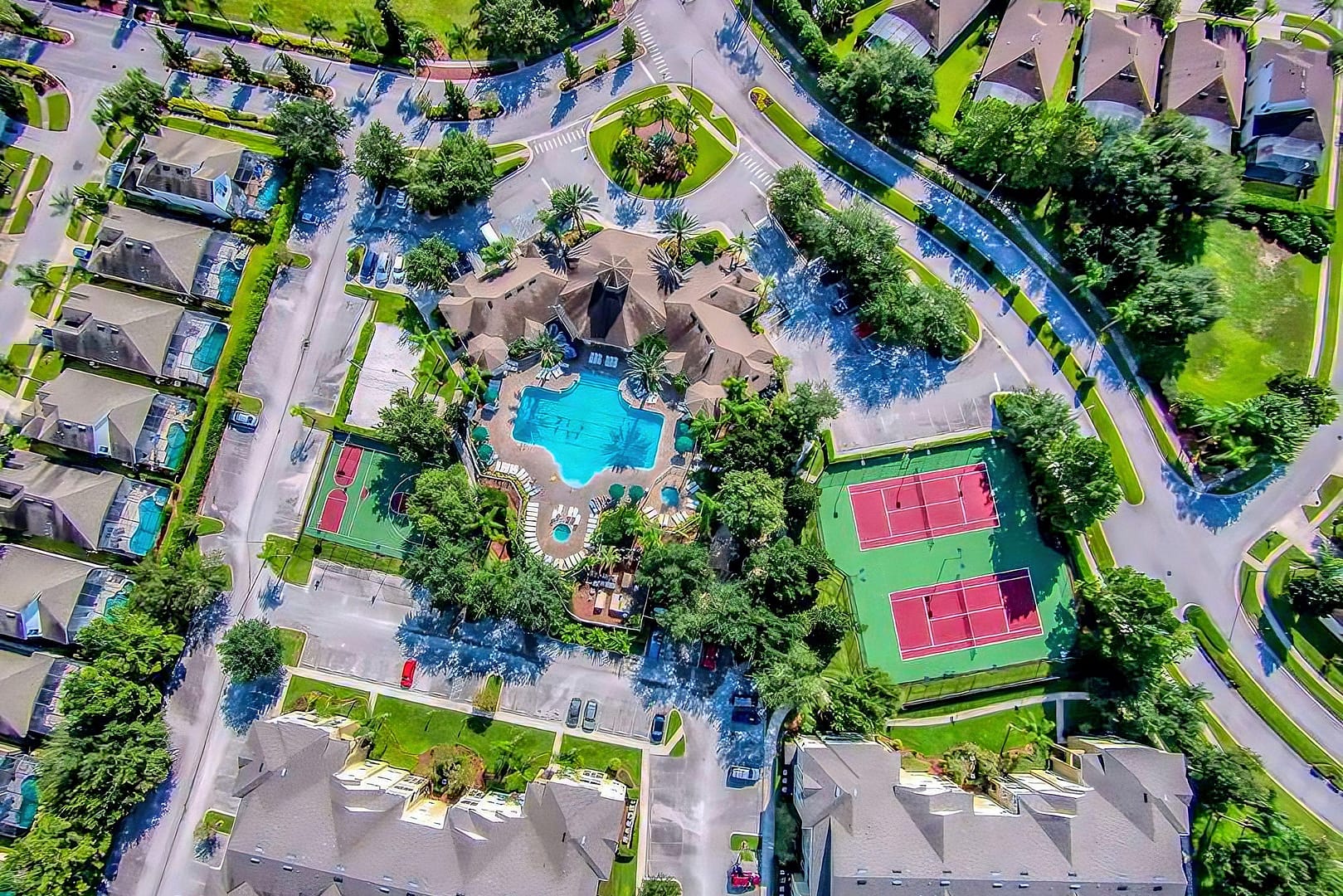 Aerial view of the Windsor Palms Resort community showing the Pool, Tennis Courts, Clubhouse, Basketball courts, surrounding streets and houses.